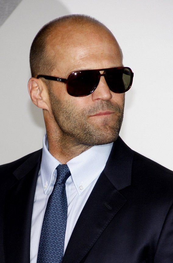 Jason Statham in navy suit and glasses